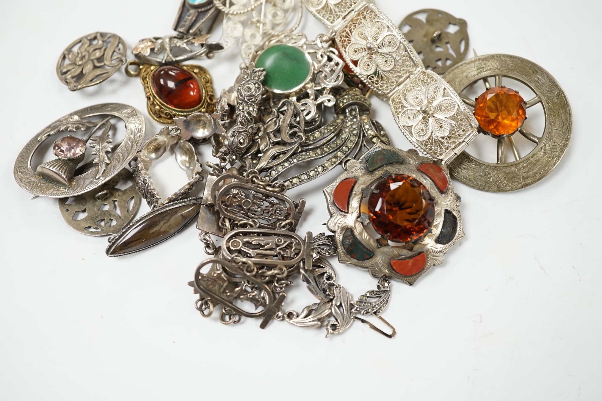A small quantity of assorted silver and white metal jewellery including filigree bracelet, Scottish hardstone and gem set brooches, etc. Condition - poor to fair